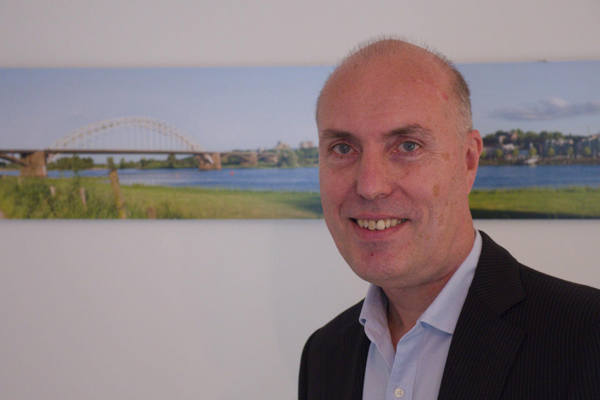 Rene Portrait van Rene met een beeld van de waalbrug op de achtergrond